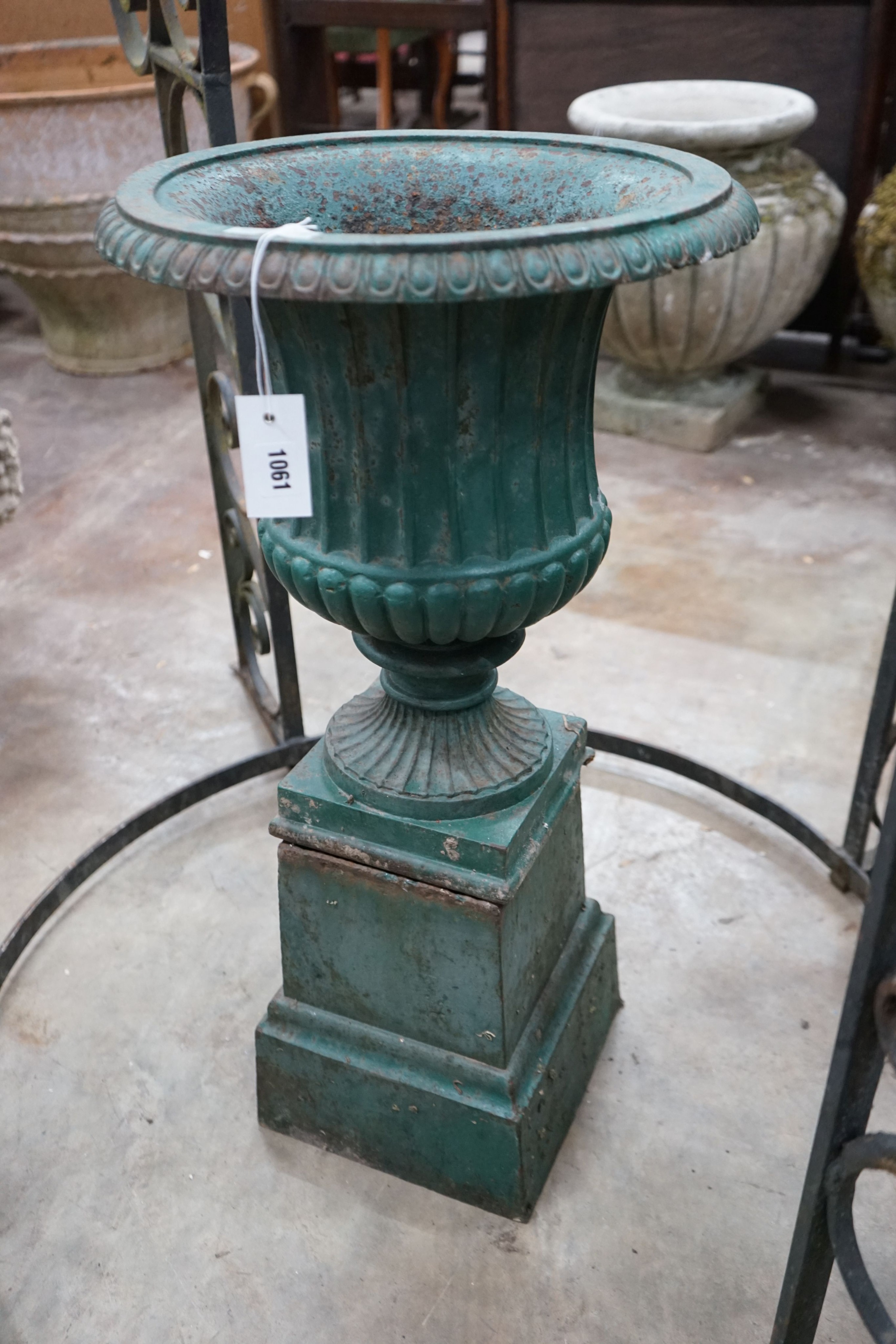 A Victorian painted cast iron campana garden urn on square pedestal stand, diameter 40cm, height 80cm